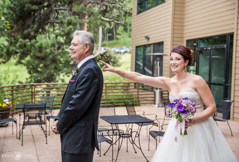 Bride shows her dad her dress at The Pines at Genesee