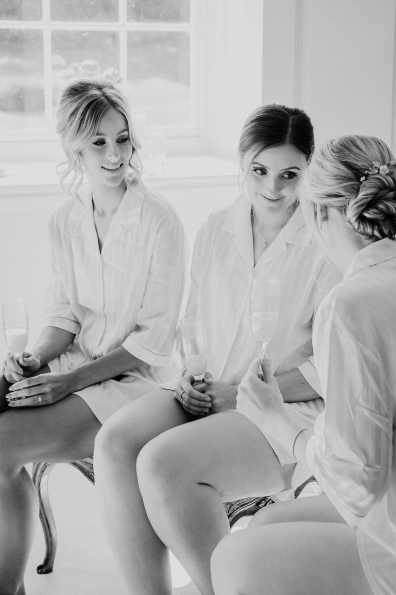 Bridesmaids chatting while getting ready