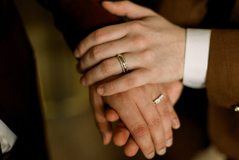 two grooms holding hands