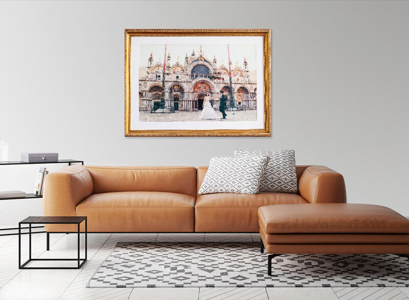 Photo of bride and groom outside St. Mark's Basilica hanging above brown couch
