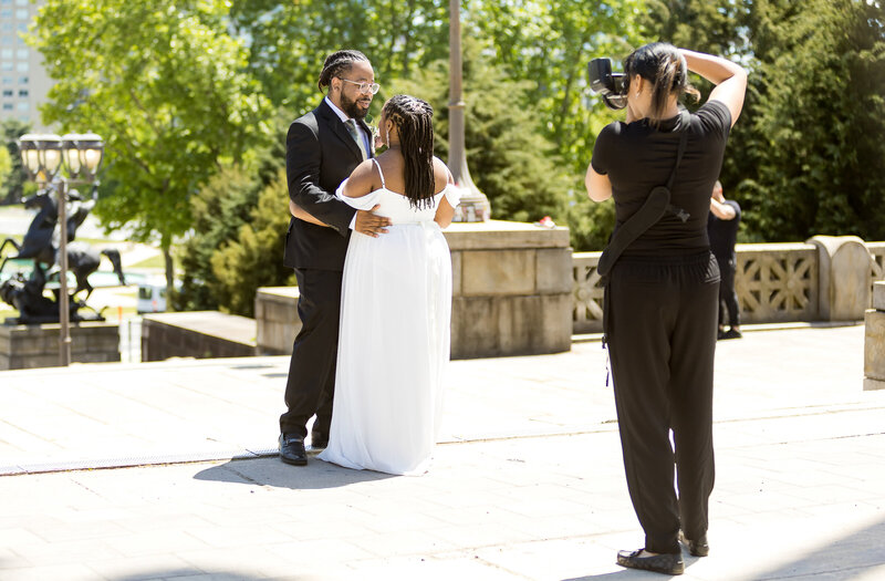 behind the scenes with black owned Philadelphia, PA Wedding photographer with a black young wedding couple. Couple is happy.
