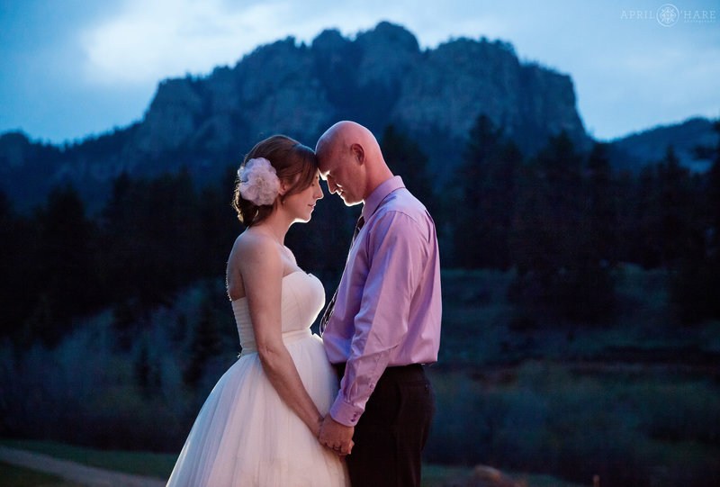 Pretty backlit couples portrait at dusk with Lions Head rock formation backdrop