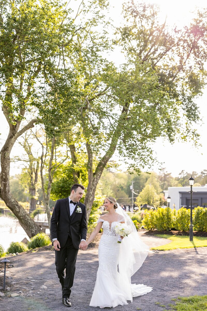 english manor bride and groom holding hands