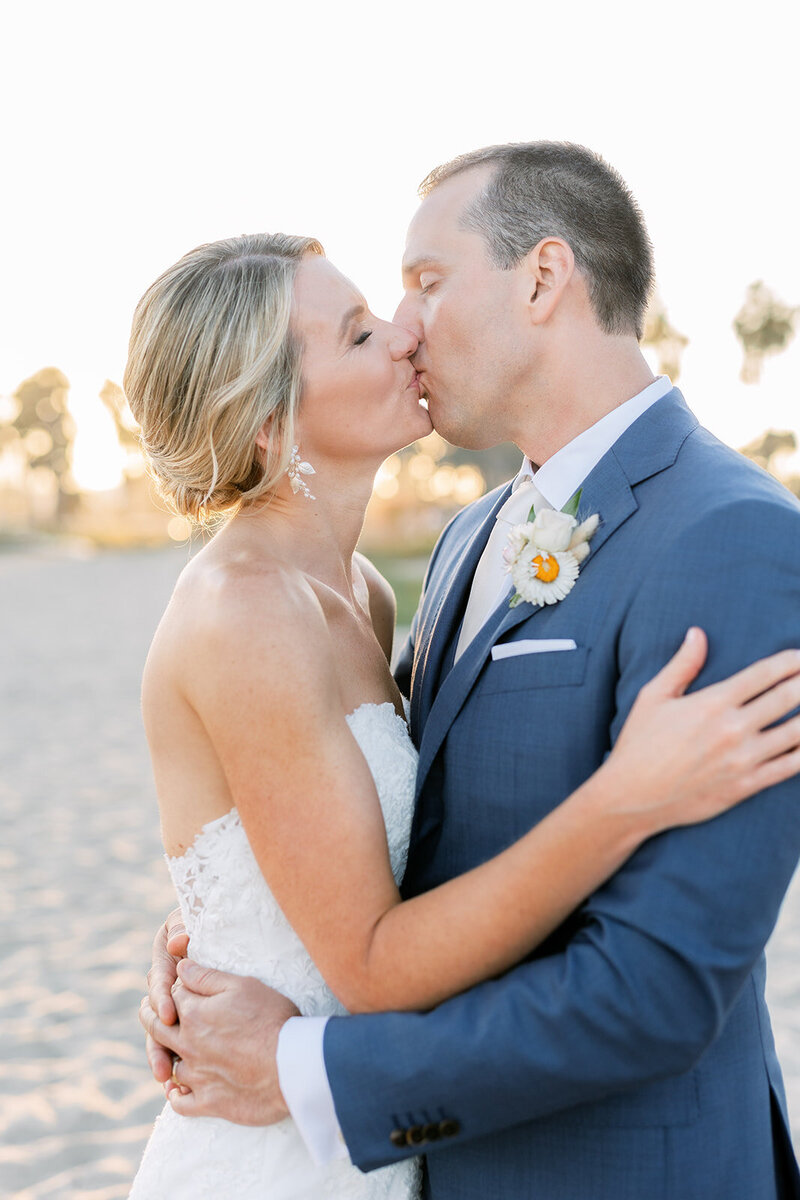 Bride and groom stand forehead to forehead outdoors in Ojai