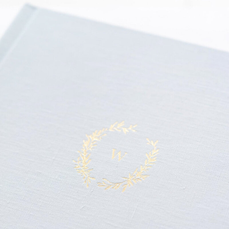 Gold debossing on a blue linen album by Washington DC Family Photographer