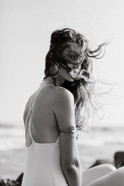 Woman at the beach with her hair blowing in the wind