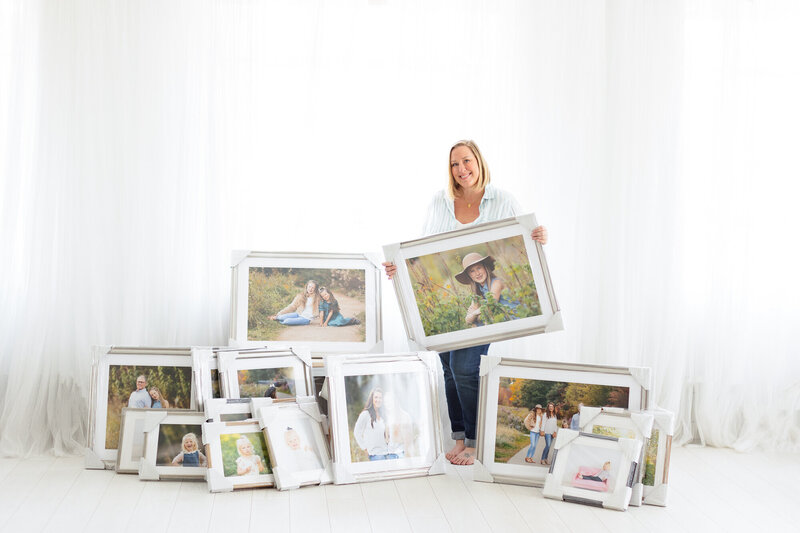 Tiffany Hix surrounded by many framed family portraits