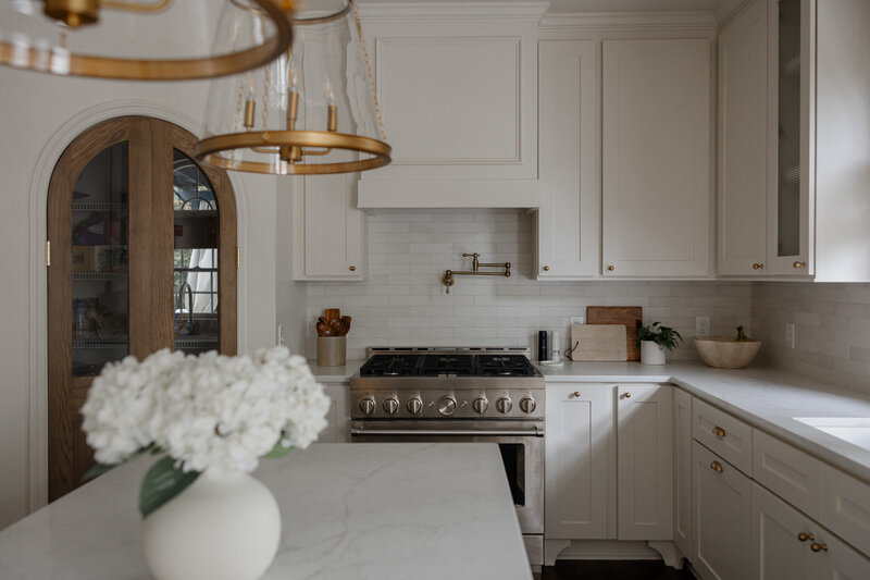 Timeless kitchen design in Roswell, Georgia with custom cabinetry, statement lighting, and functional layout by Megan Paterson Interiors.