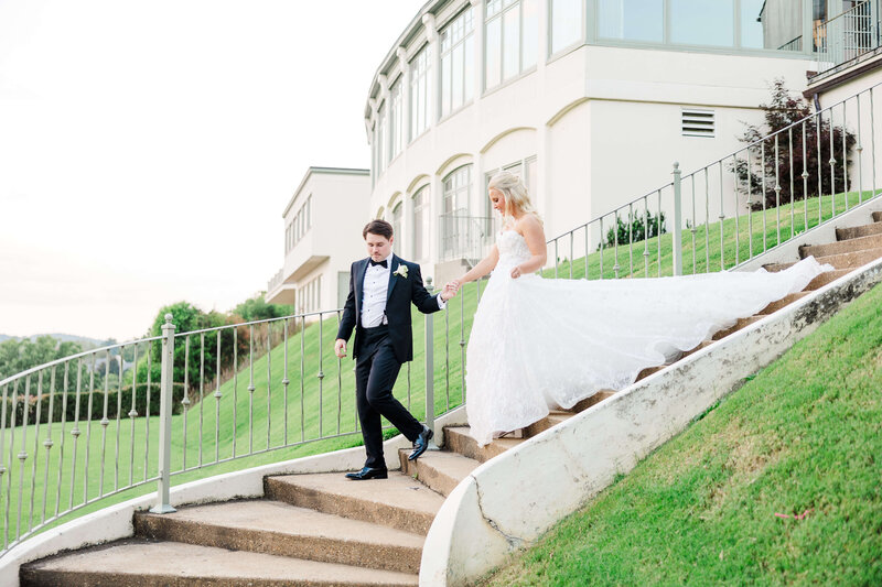 bride and groom walking down stairs by knoxville wedding photographer