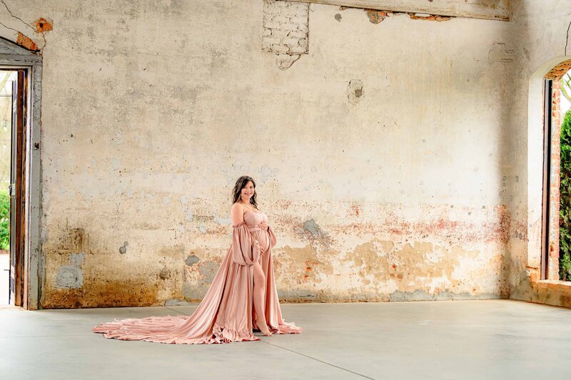 charlotte mom wearing pink silk dress in unique providence cotton mill location