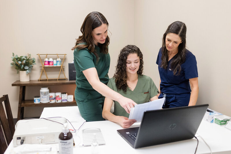 Eau Claire Acupuncture team looking at lab results