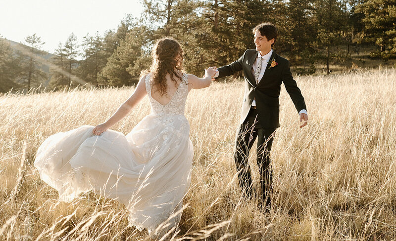 bride and groom dance in a field at sunset at Deer Creek Valley Ranch