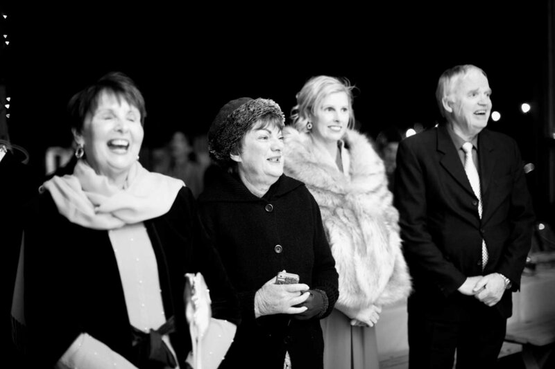 Wedding guests laughing during a speech at wedding reception