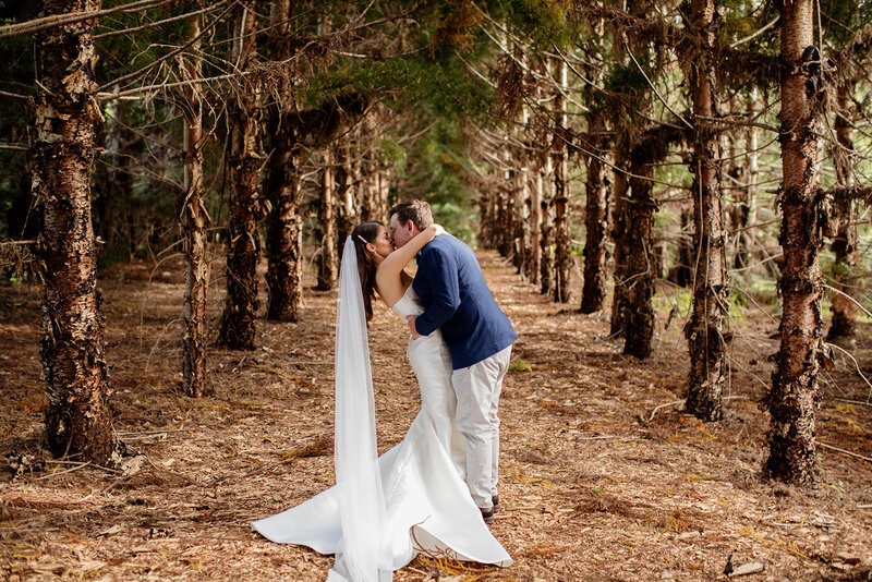 Wedding couple embrace each other at the woods