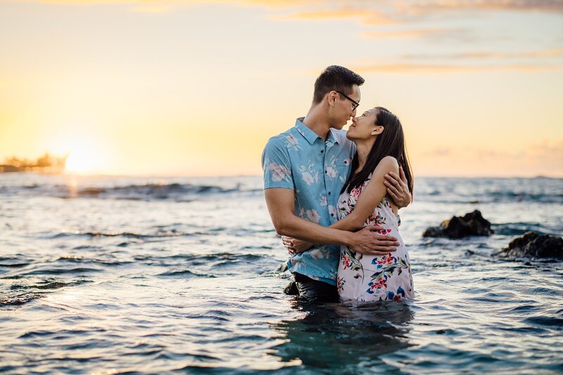 engaged couple kissing in the hawaii waters