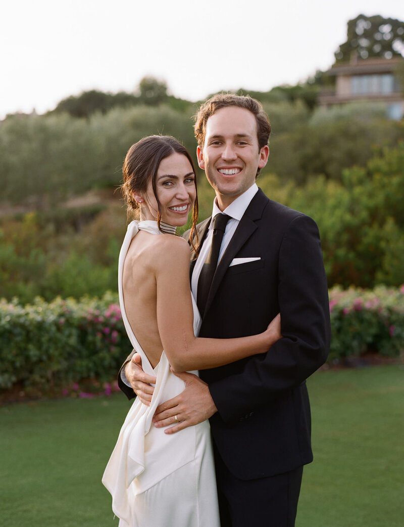 Bride and groom embrace on their wedding day at the Montecito Club