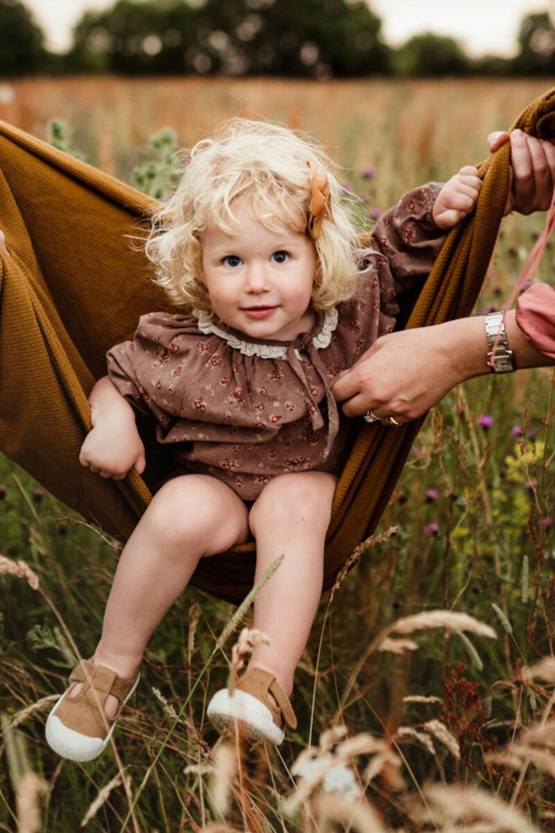 natural light little girl blanket field photoshoot