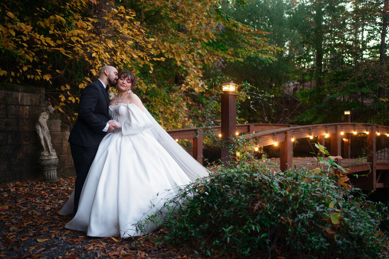 A bride and groom kissing during their wedding photo session at Rocky's Lake Estate in woodstock georgia