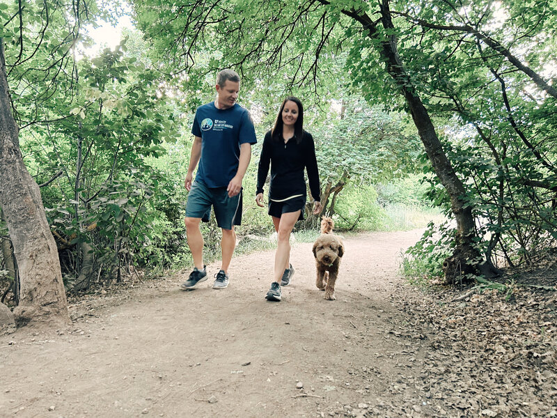 Married couple with their dog hiking in the mountains off leash | Cornerstone Dog Training