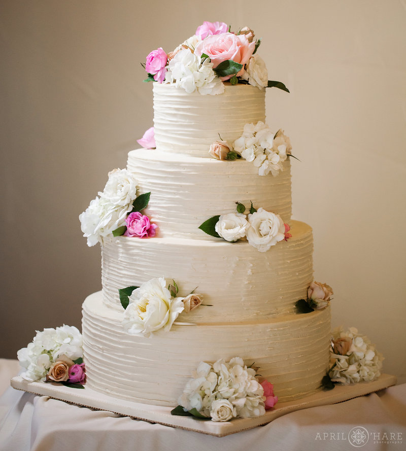 Four-Tier-White-Wedding-Cake-with-Florals-by-Blue-Moon-Bakery-in-Dillon-Colorado