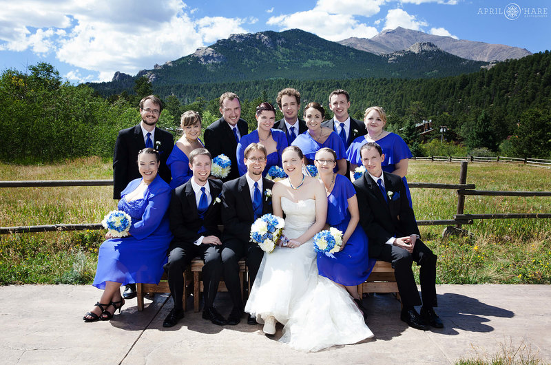 Bright sunny wedding day photo at the Meadow at Wild Basin Lodge with mountain backdrop in Colorado