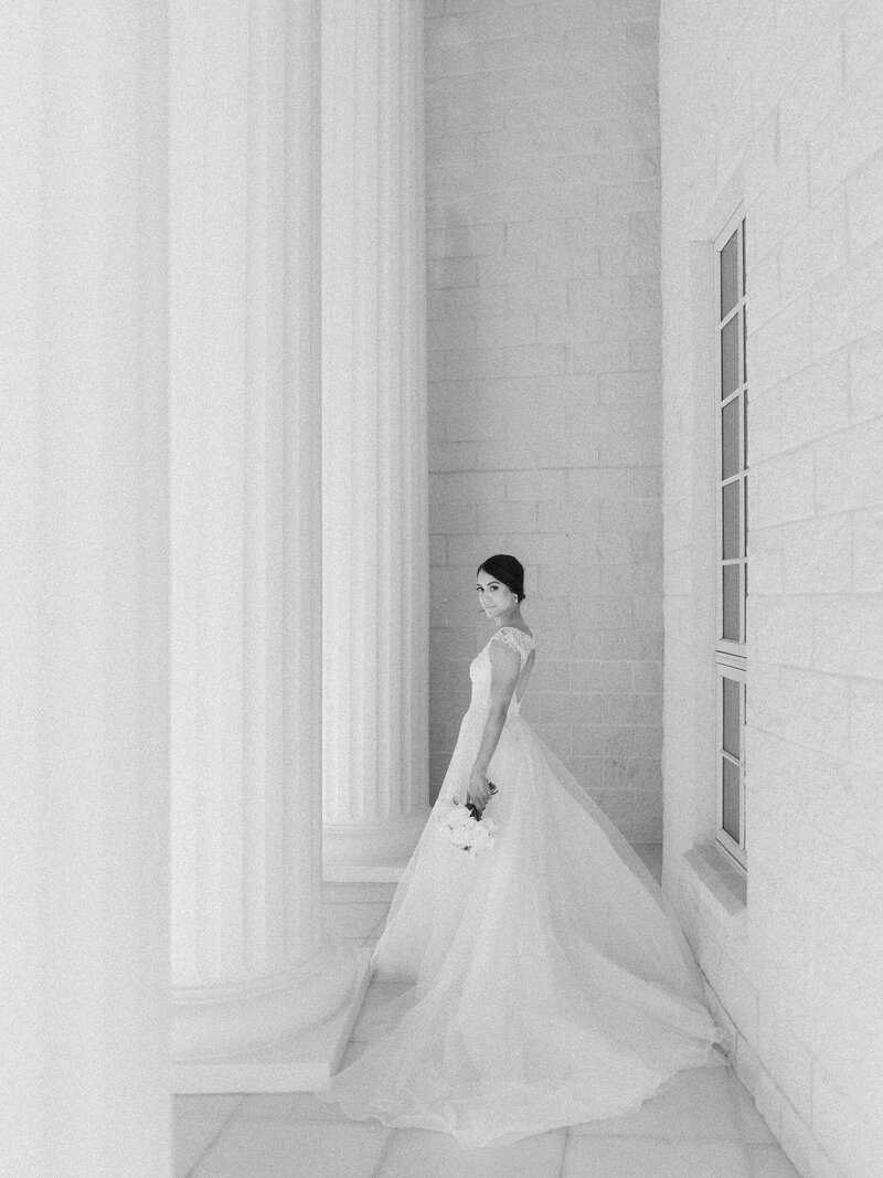 Black and white bridal portrait amongst columns