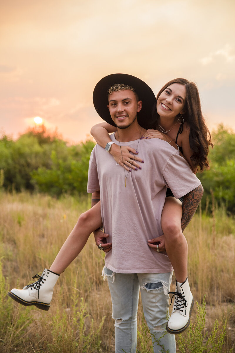Couples portrait session with piggy back rides and cuddles in northern colorado