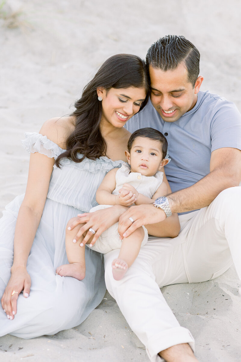 family on beach sitting with baby boy philadelphia newborn photographer