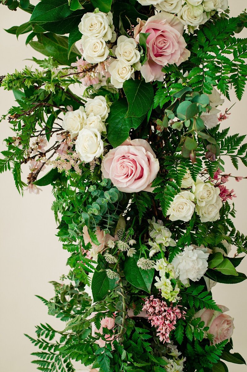 Greenery and rose filled flower instillation for modern wedding arbor