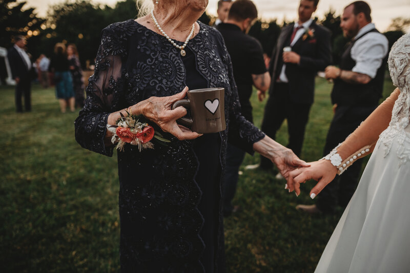 Baltimore photographers captures detail shot of bride with grandmother on wedding day while holding hands