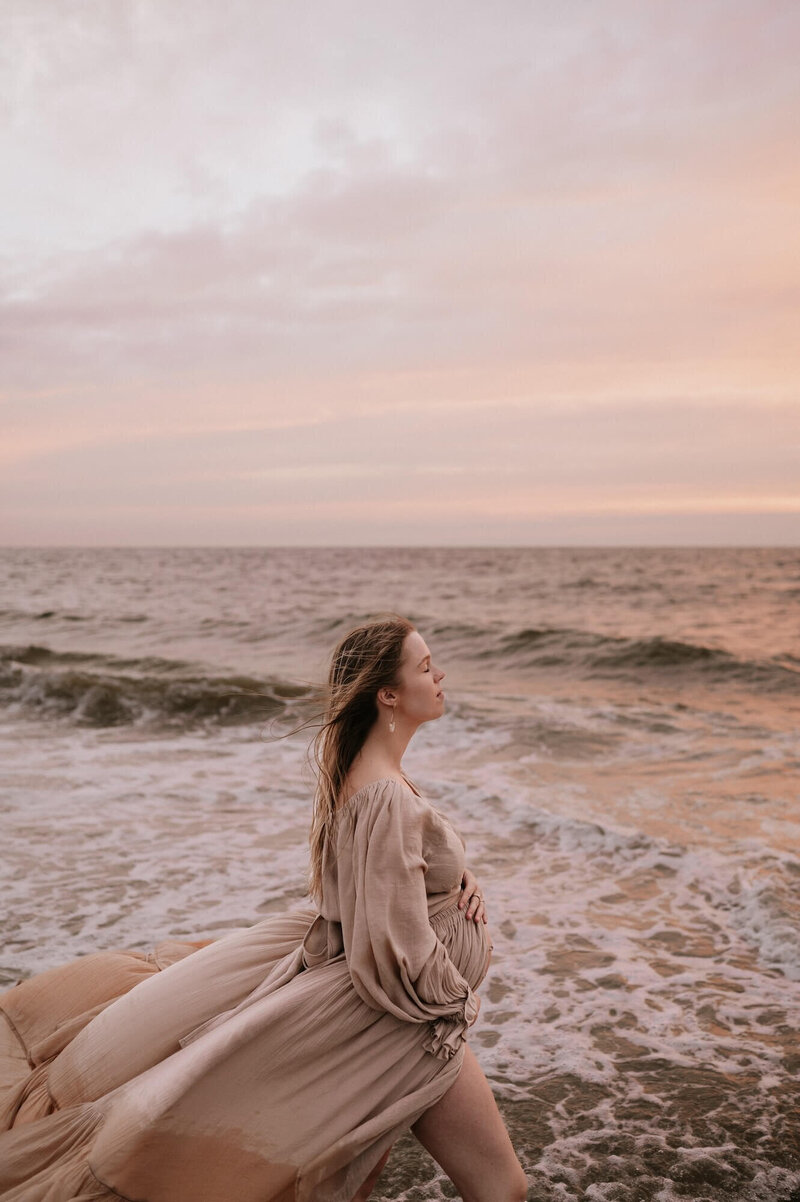 Zwangerschapsshoot op het strand bij zonsondergang