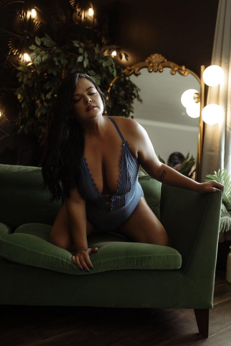 Blue lingerie and green couch boudoir pose