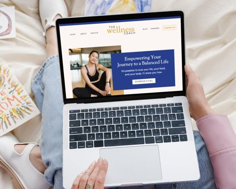 Website Mock-Up of a blue and yellow Showit web design for a for a wellness coach.