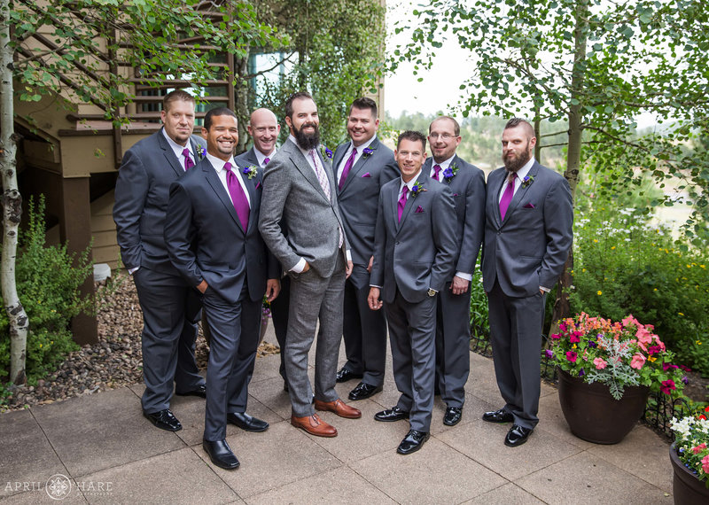 Groom with his friends gathered on the outdoor patio area at The Pines at Genesee