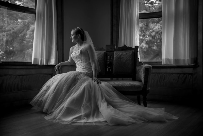 bride sitting by window at Joslyn Castle in Omaha Nebraska