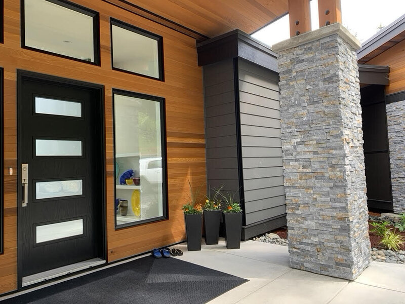 West Coast contemporary home entry with cedar and black entrance door built by K2 Developments.