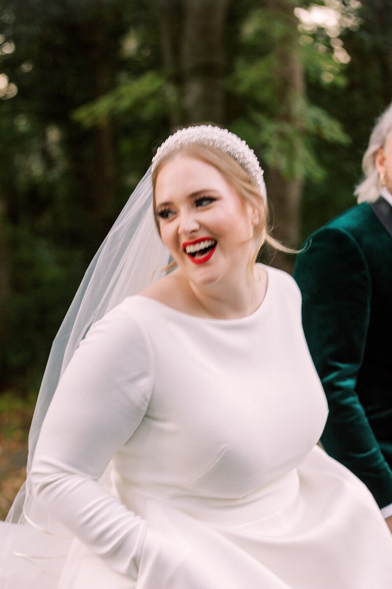 Stunning bride smiles as she looks over her shoulder