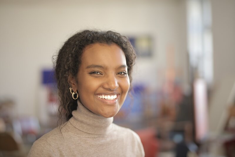 smiling-woman-in-grey-turtleneck-shirt-3869401