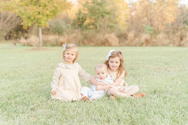 3 siblings during fall mini session taken by a Sterling, Virginia photographer