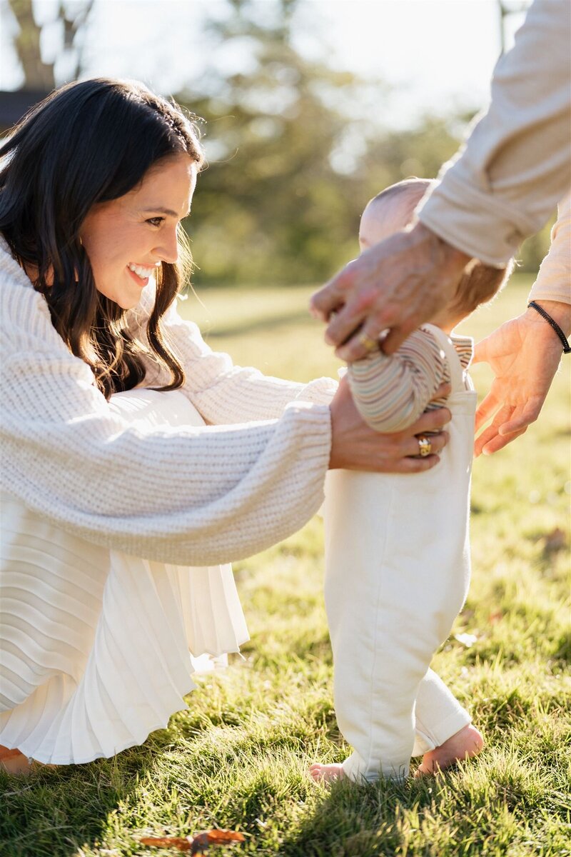 Mother holding young daughter and kissing young son