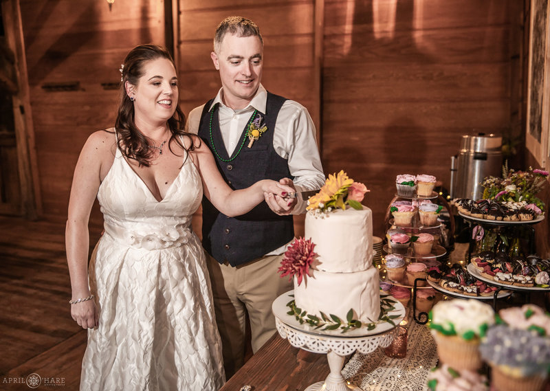 Cutting cake at Piney River Ranch wedding reception in Colorado