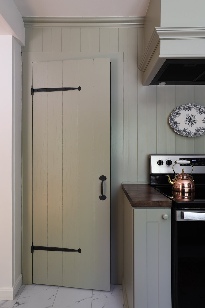 Laundry Room renovation by Nadine Stay. Rustic dark wood walls with basketweave brick floors. Brown door paint color. Mudroom built in cabinets.