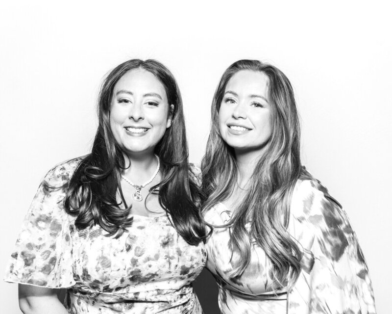 2 ladies posing against a white backdrop for a b&w filter during a kardashian glam photo booth hire
