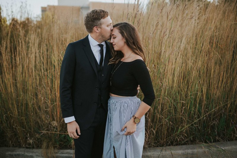 Jennifer and Steven Van Elk Wedding photographers kiss in a field