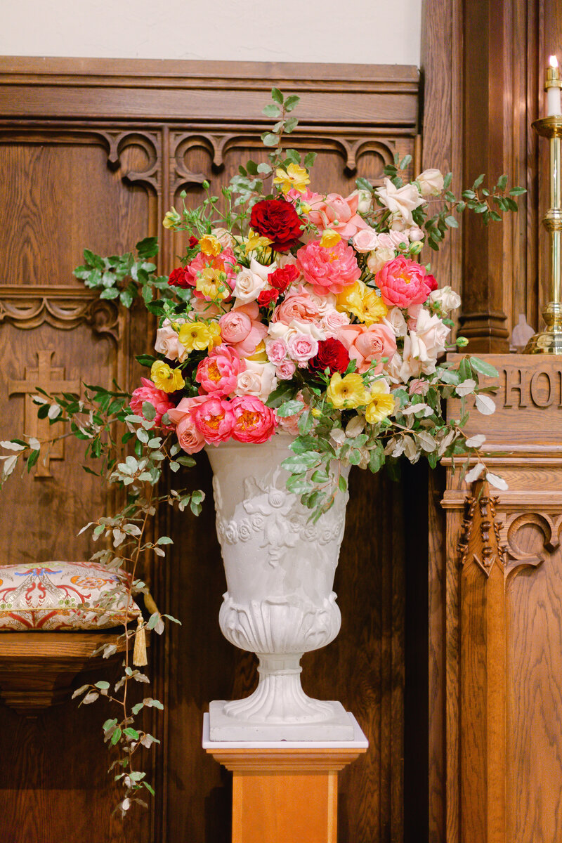 wedding florals in white vase in church