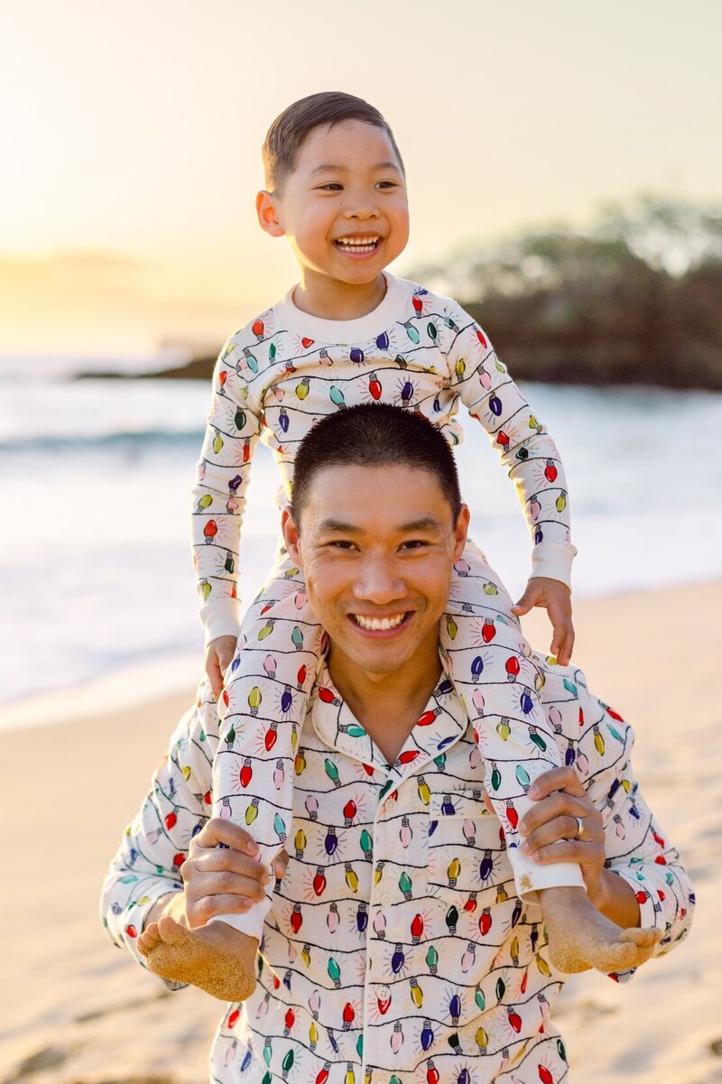 dad and son in Christmas pajamas for a beach Christmas on Maui