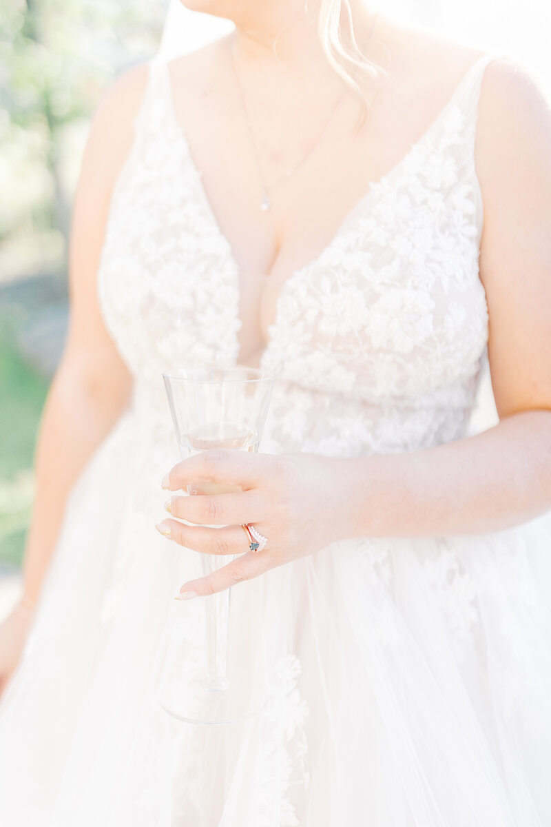 Bride holds a glass of champagne