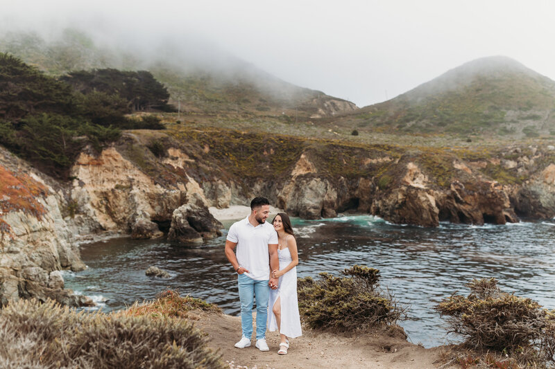 couple posing in front of iconic Big Sur landscape