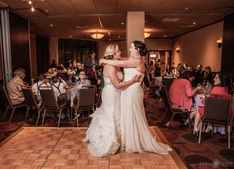 Two brides dance in the small ballroom Golden Vista at The Golden Hotel
