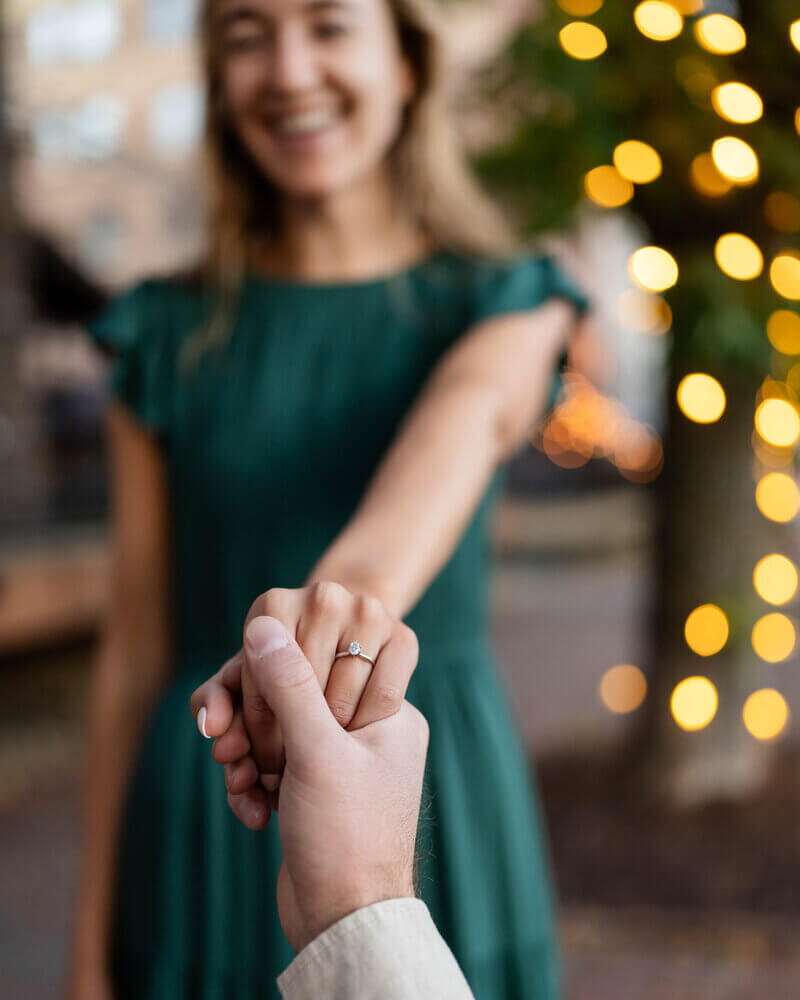 fiances holding hands and woman smiling by Proposal photographer atlanta